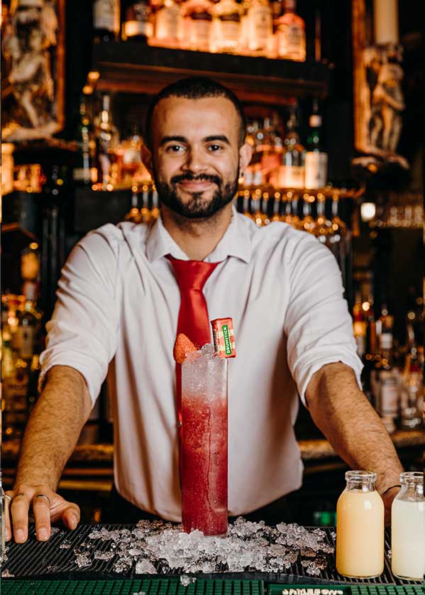 A barman presents you a large cocktail